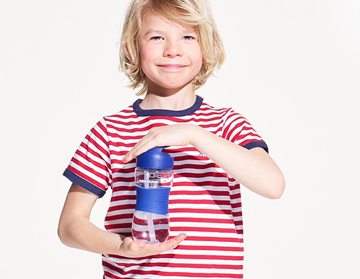 Enfant tenant une gourde Okaïdi