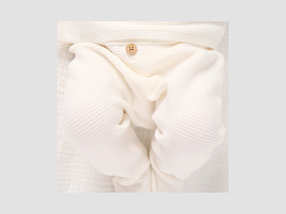 Geboorte witte gebreide gebreide broek op voet 1